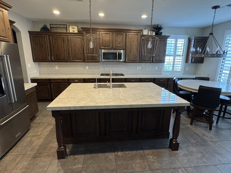 Large porcelain kitchen island with undermount sink and stained alder cabinetry, Chandler, AZ